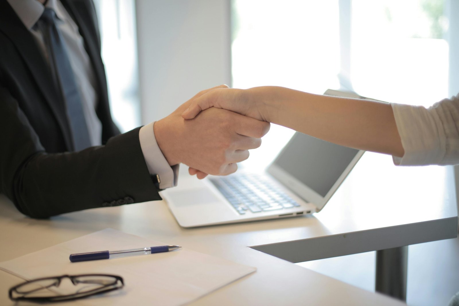 HR manager shaking hands with candidate after interview confirmation