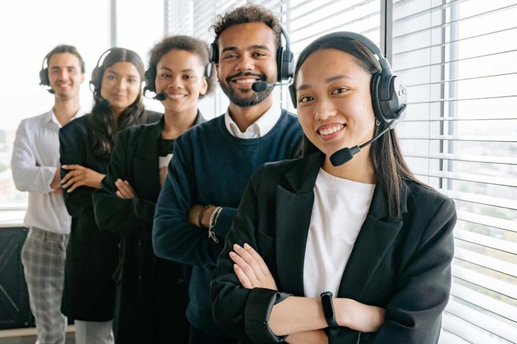 A diverse group of customer service agents, all wearing professional headsets