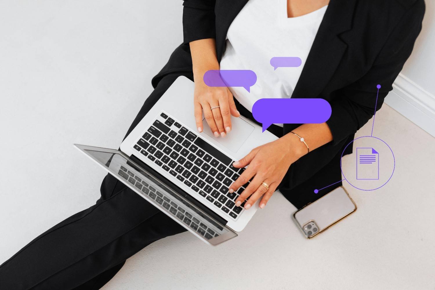 A woman in a black suit using a laptop